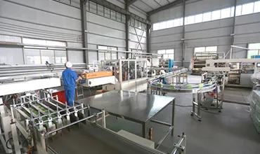 Toilet paper being rewound on a machine for packaging.