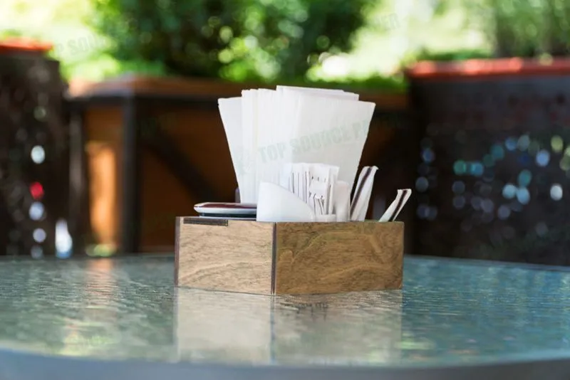 Close-up of stylish paper napkins arranged on a glass table.