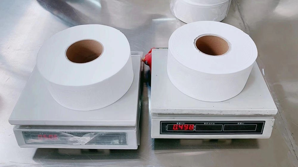 Carton display of commercial jumbo bath tissue rolls packed for wholesale distribution