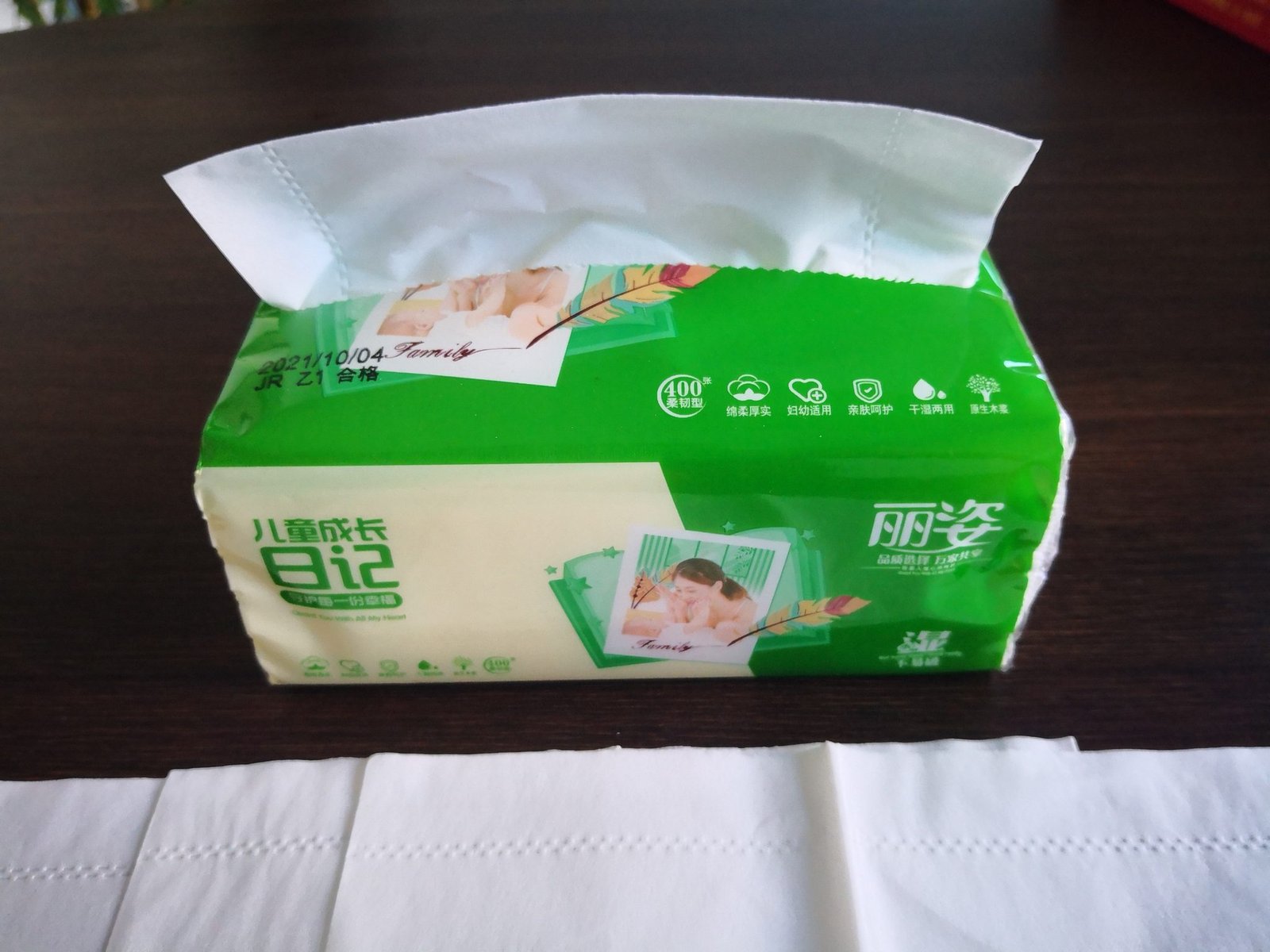 Cube box of commercial facial tissue with sheets displayed for fixture and restock planning