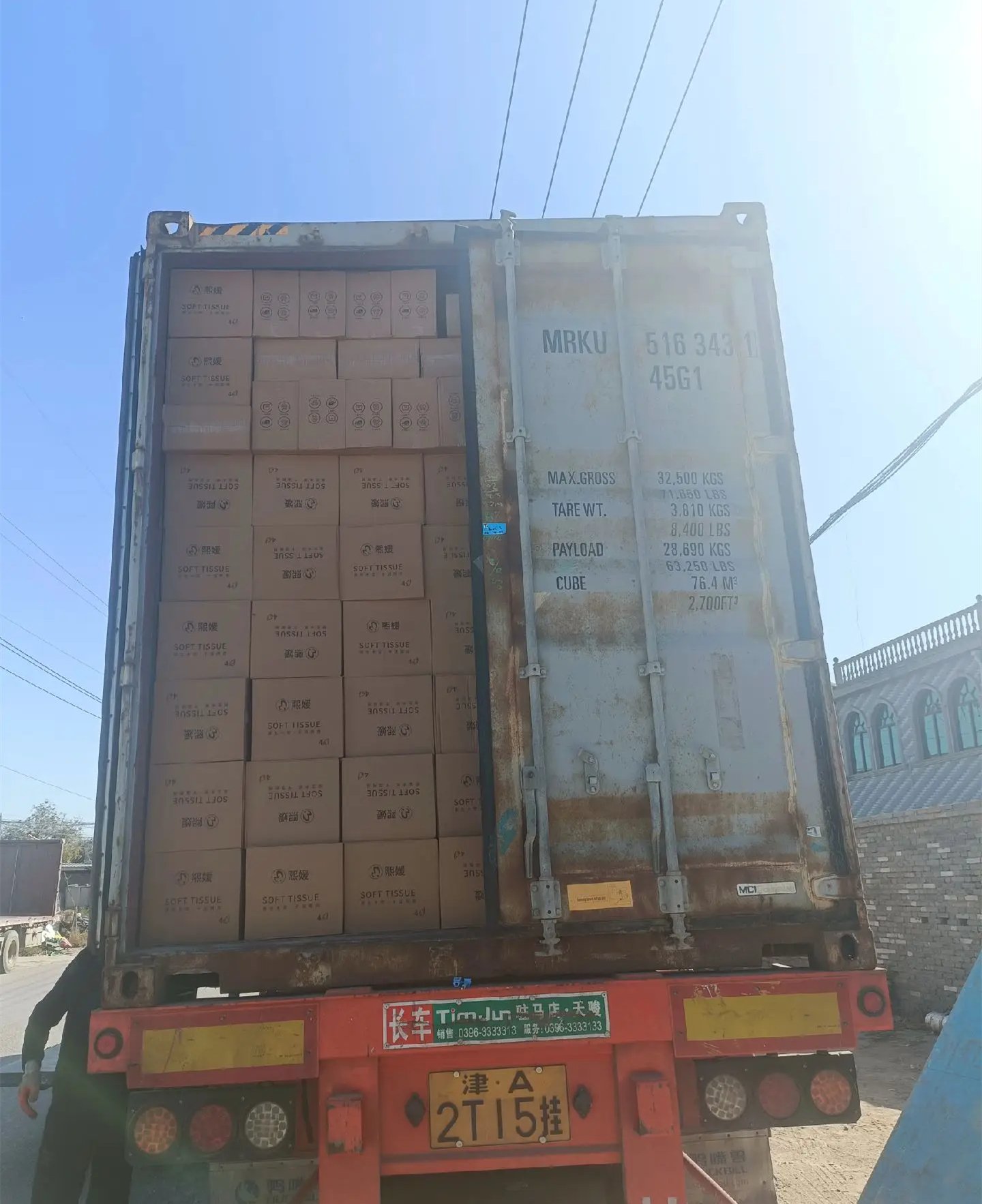 Export container being loaded with palletized tissue cartons