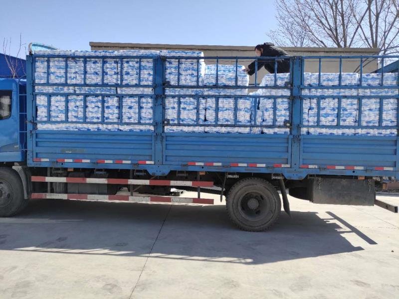 Truck loaded with shrink-wrapped tissue packs at the mill dispatch yard