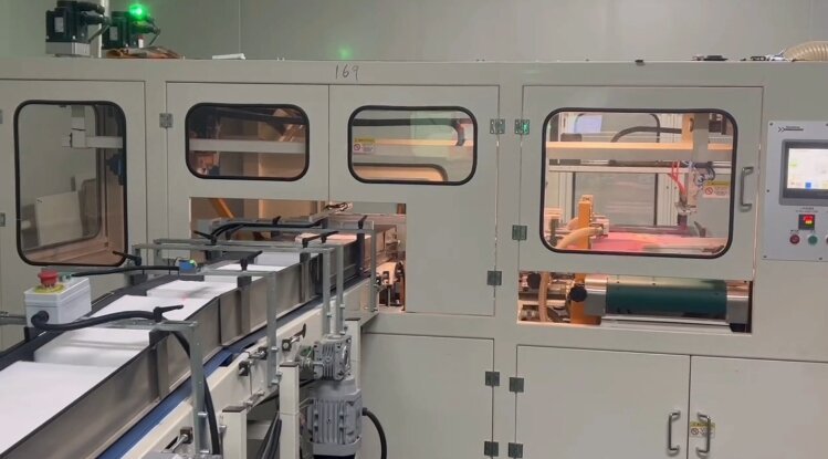 Automatic hand towel folding machine running with conveyor outfeed and HMI panel