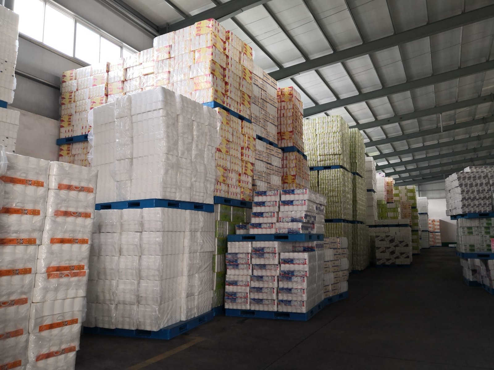 Top Source Paper warehouse with palletized tissue paper containers ready for shipping